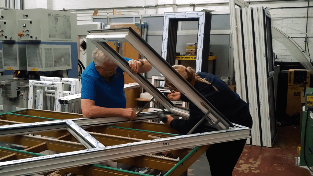 business owner nigel and his daughter constructing a upvc window profile